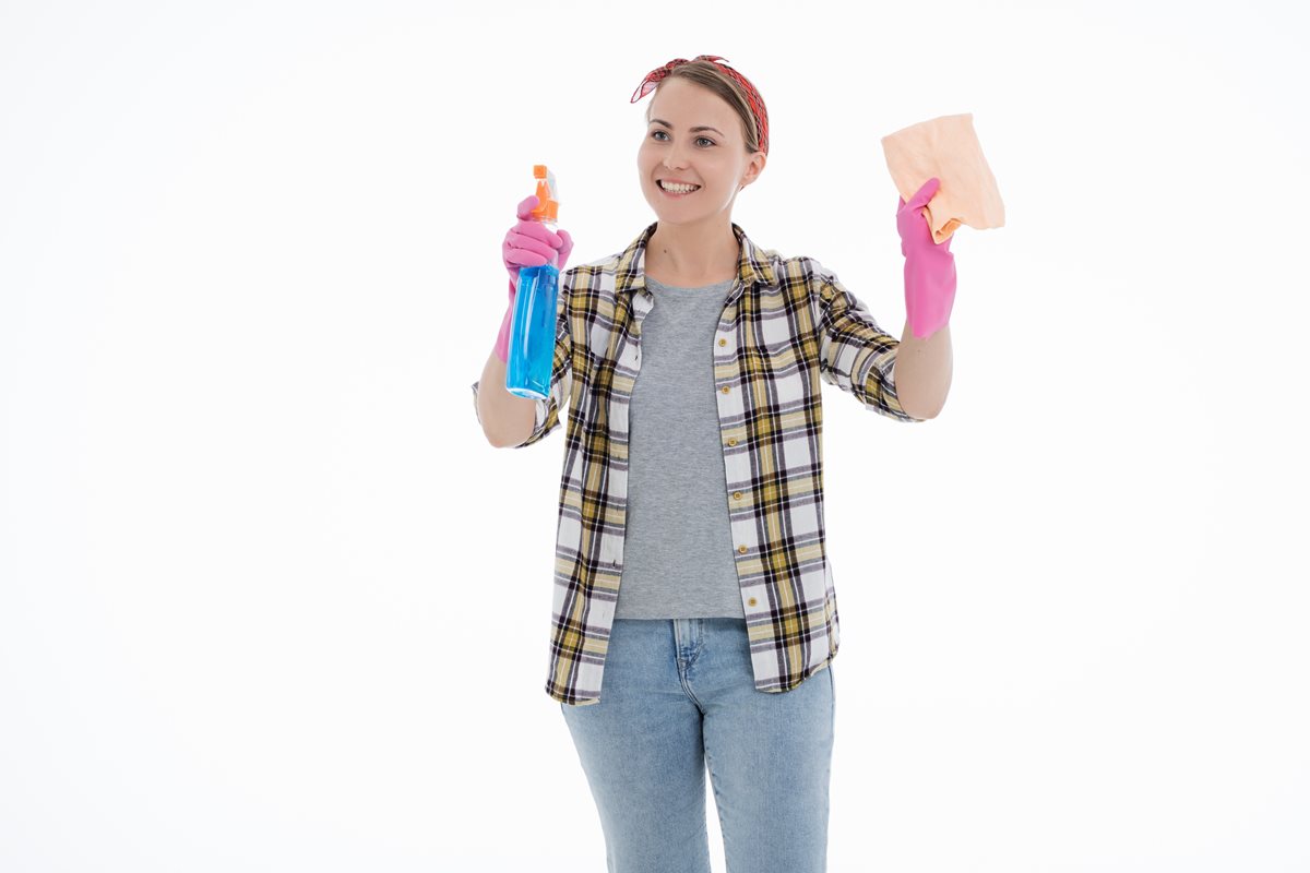 Image of a woman facing the camera dressed as a cleaner and cleaning an imaginary surface
